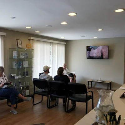Patients watching television in the waiting room at Evolve Dental